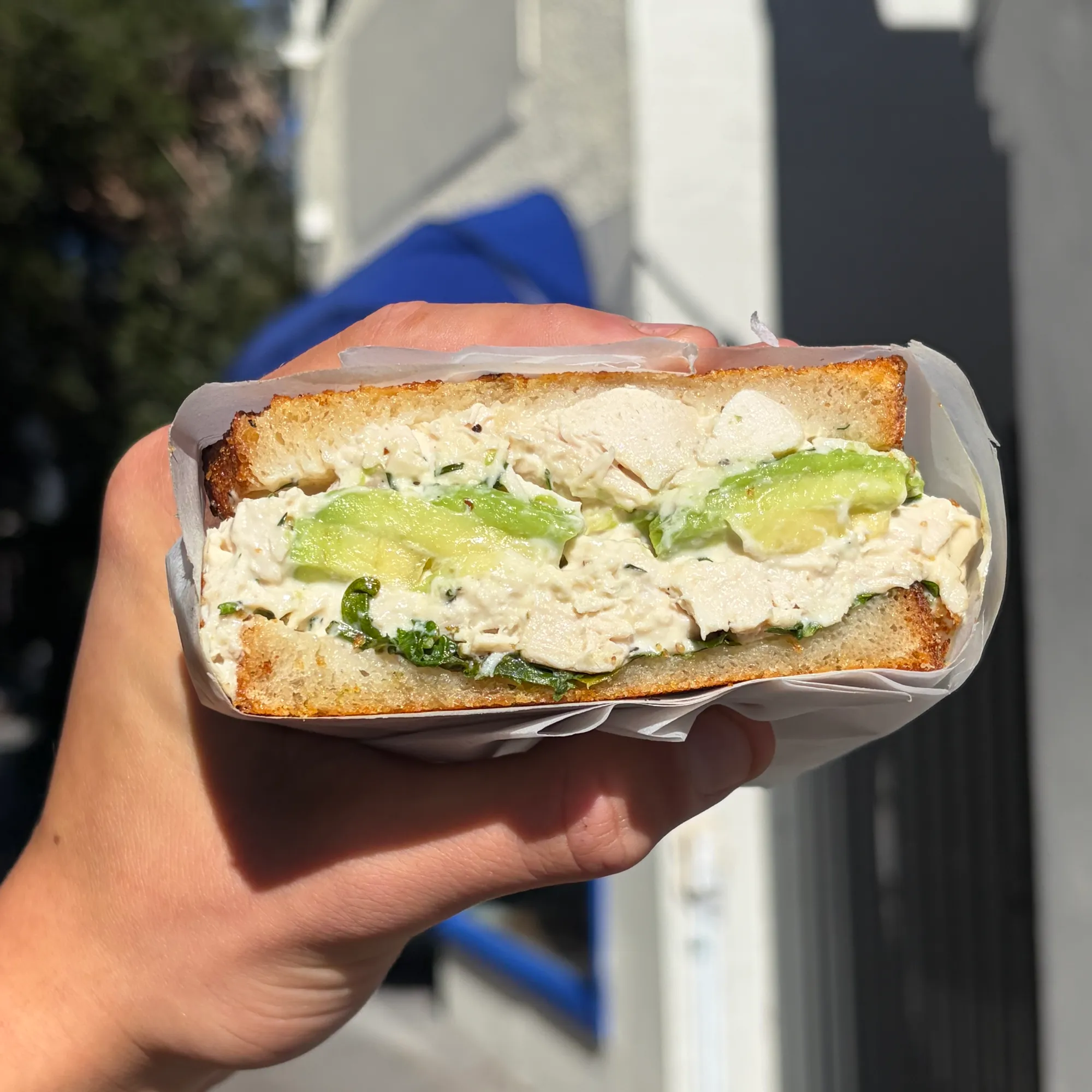 Lil Sebs team member serving a sandwich